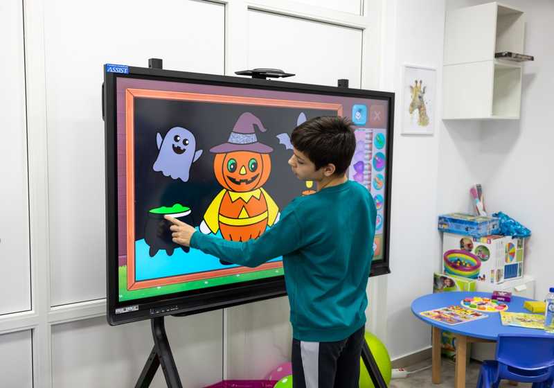 Child playing with the smart tablet donated by the foundation.