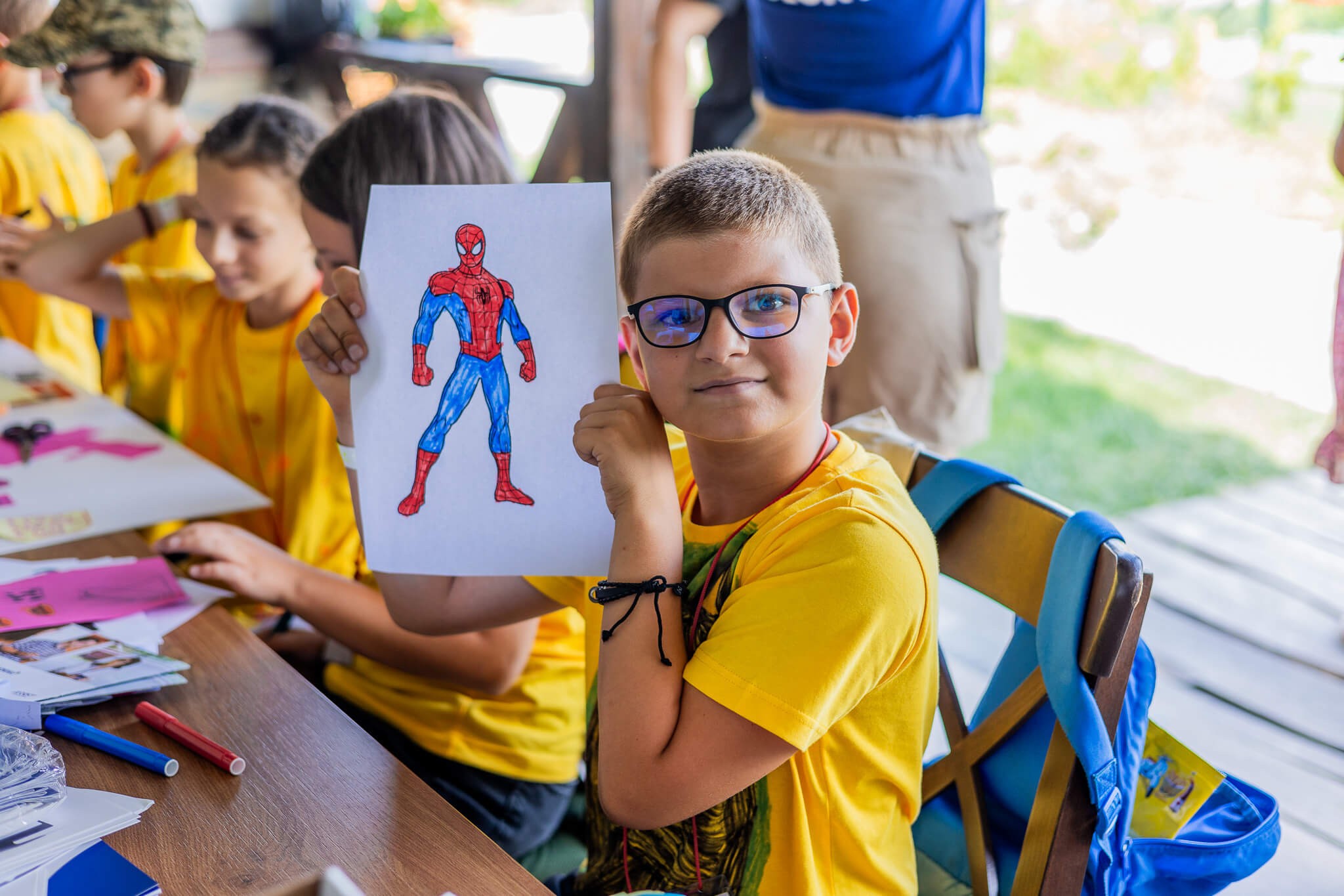 Boy holding his drawing
