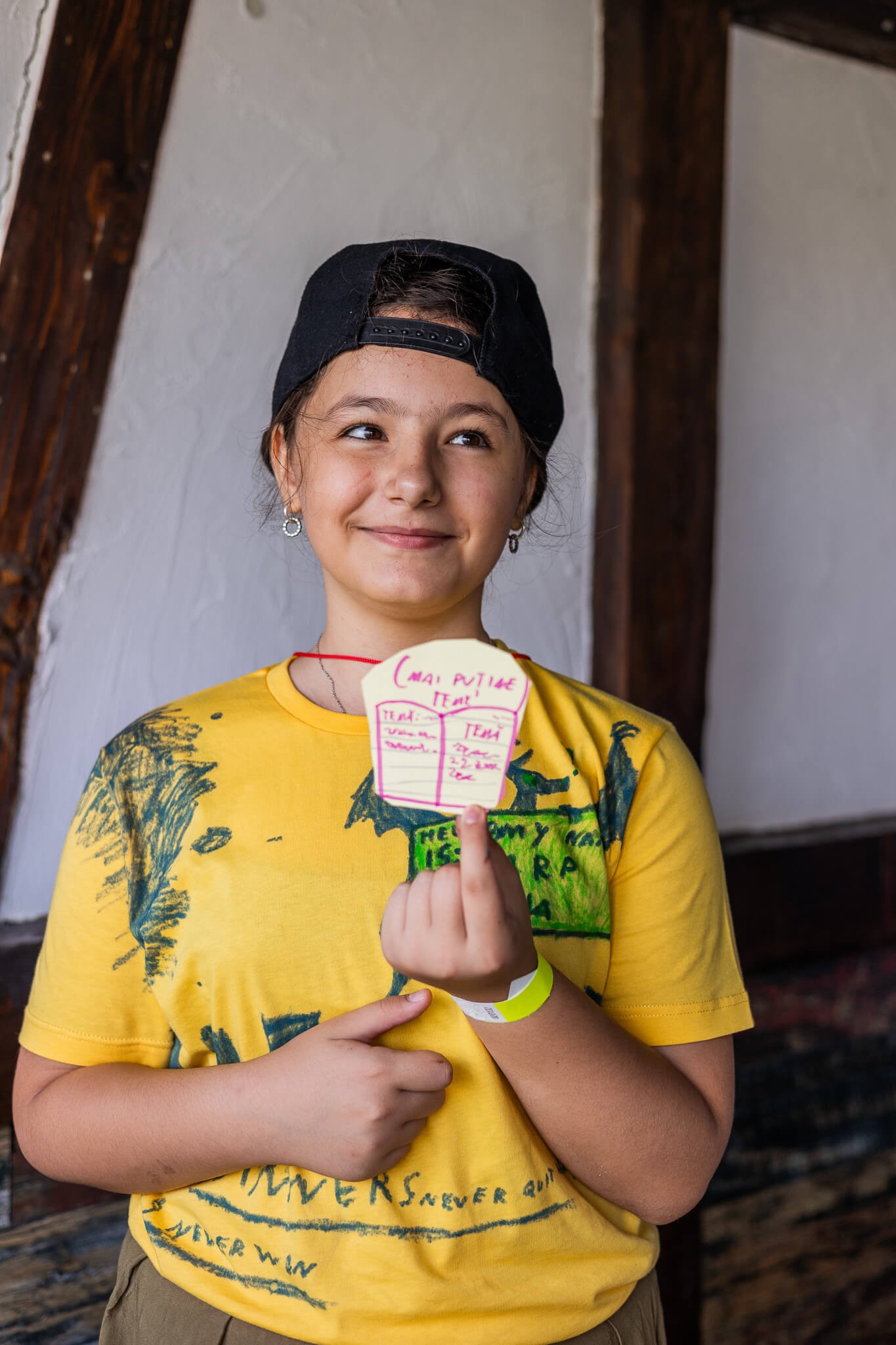 Girl holding her drawing